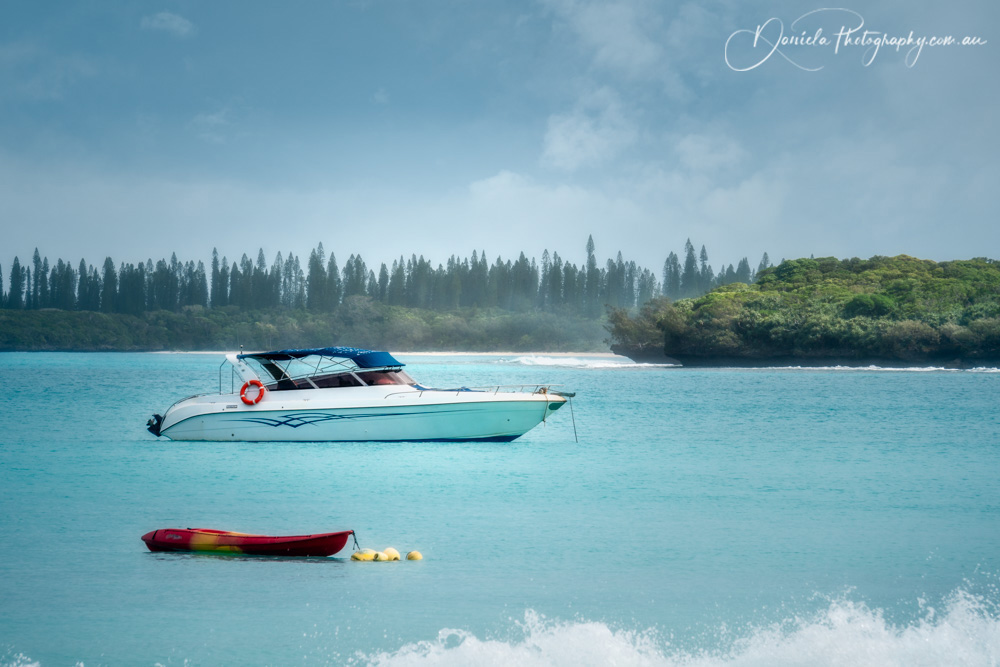 Boats on the water at Kuto Bay on Isle of Pines in New Caledonia